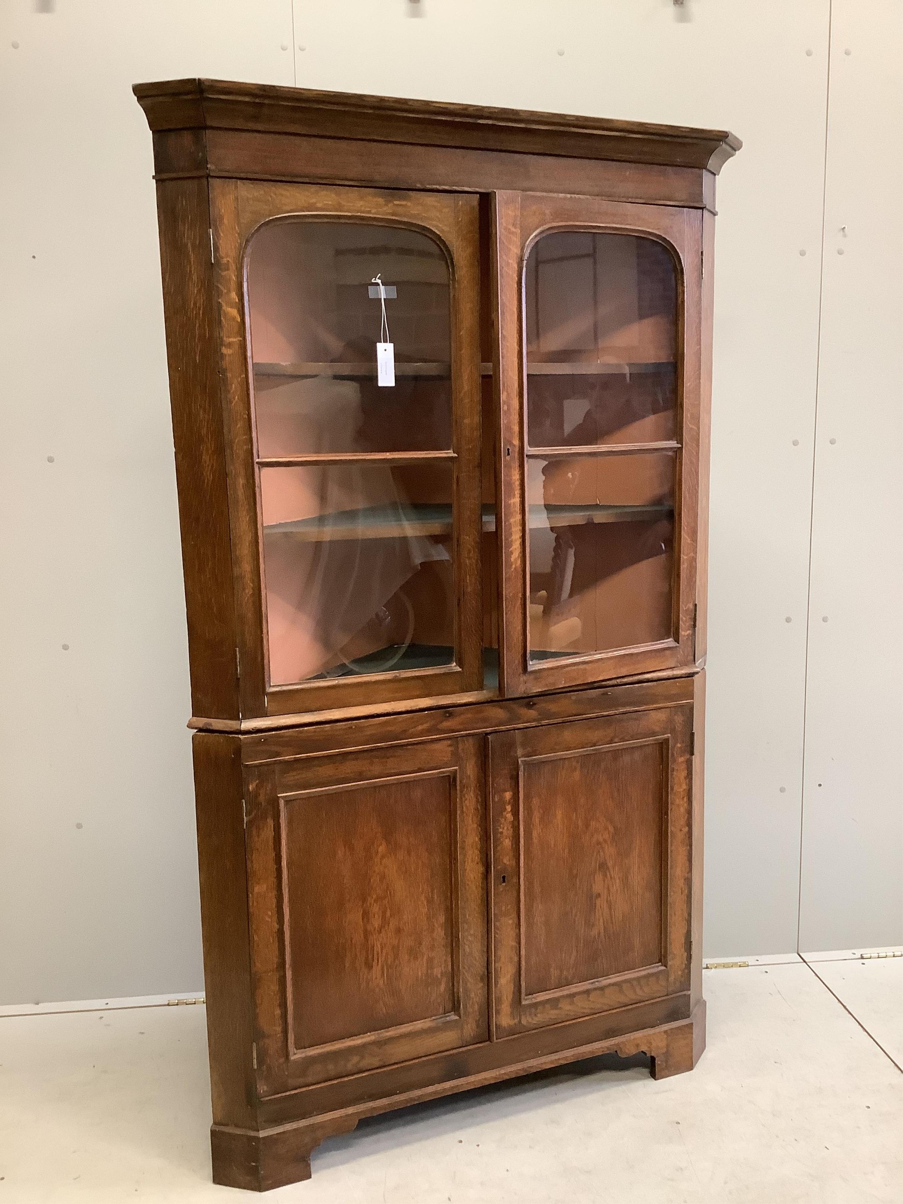 A George III oak oak standing corner cupboard, width 114cm, depth 52cm, height 191cm. Condition - fair